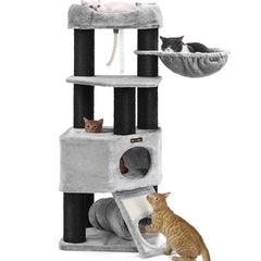 A multi-level cat tree featuring several cats resting and playing on different platforms, including a hammock, cozy beds, and a scratching post.